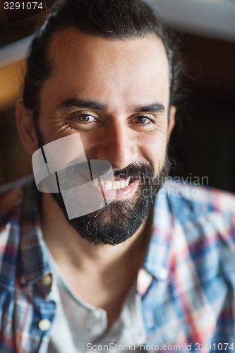 Image of happy young man with beard and mustache