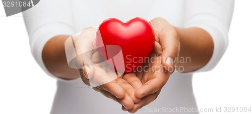 Image of womans cupped hands showing red heart