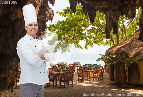 Image of happy male chef cook with crossed hands