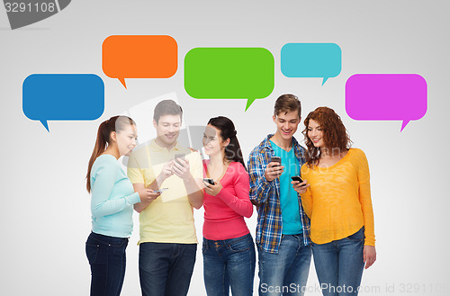 Image of group of smiling teenagers with smartphones