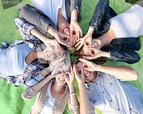 Image of group of students or teenagers lying in circle