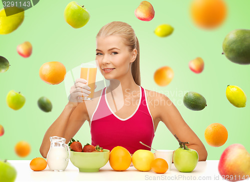 Image of happy woman holding glass of orange juice