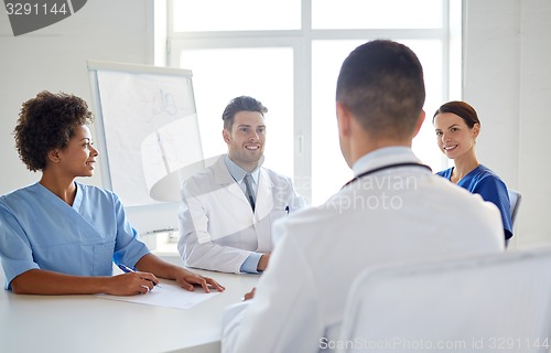 Image of group of happy doctors meeting at hospital office