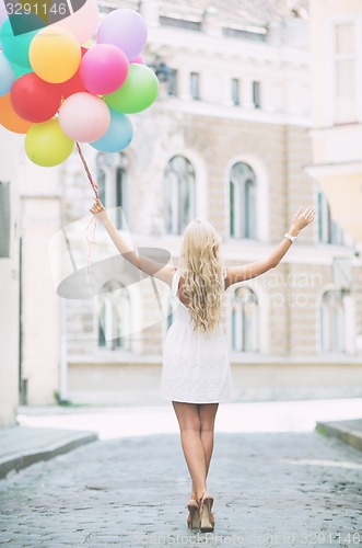 Image of woman with colorful balloons