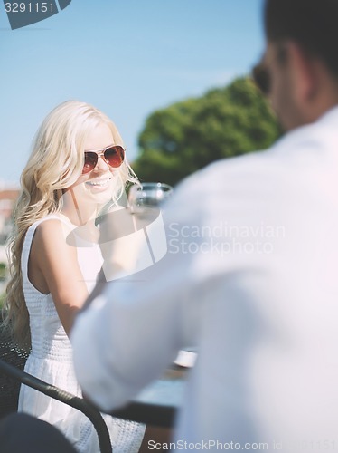 Image of couple drinking wine in cafe