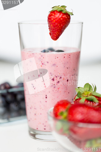 Image of close up of milkshake decorated with strawberry