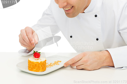 Image of close up of male chef cook decorating dessert