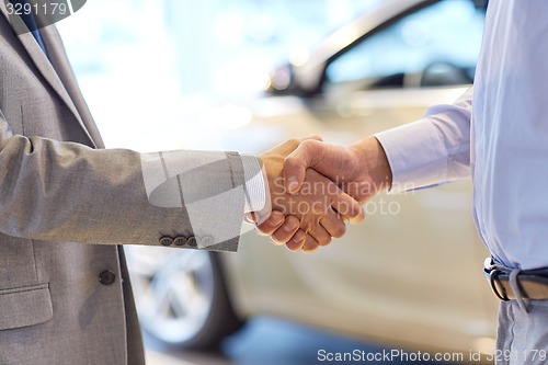 Image of close up of male handshake in auto show or salon