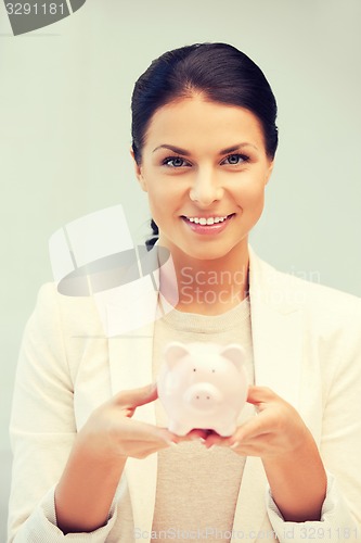 Image of lovely woman with piggy bank