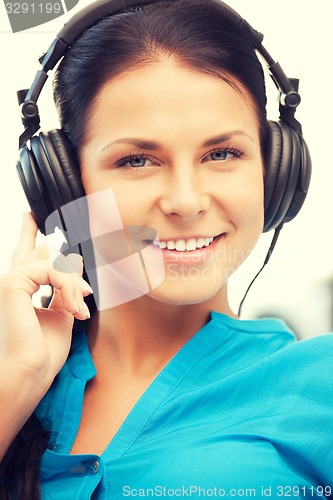 Image of happy teenage girl in big headphones