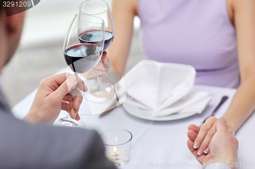 Image of young couple with glasses of wine at restaurant