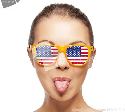 Image of happy teenage girl in shades with american flag