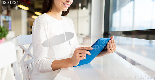 Image of close up of woman with tablet pc at cafe