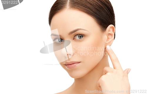 Image of woman touching her ear