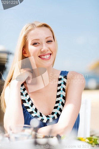 Image of girl in cafe on the beach