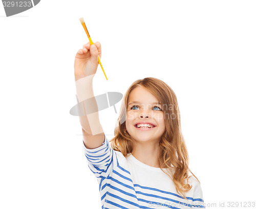 Image of cute little girl drawing with brush in the air