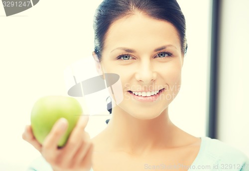 Image of woman in the kitchen with an apple