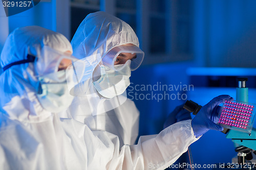 Image of close up of scientists making test in chemical lab