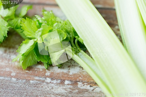 Image of close up of celery stems on wooden table