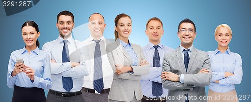 Image of group of happy businesspeople with crossed arms