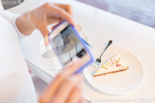 Image of woman hands with smartphone taking food picture