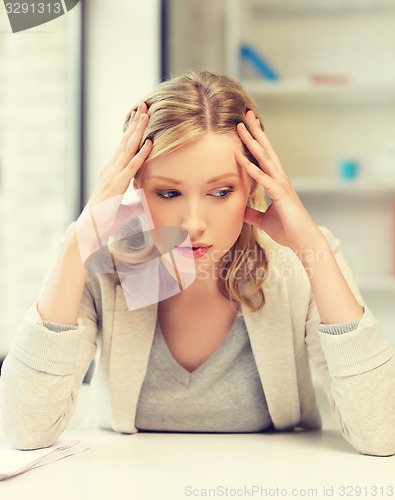 Image of bored and tired woman behind the table