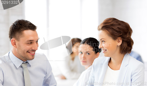 Image of usiness colleagues talking in office