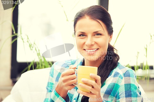 Image of lovely housewife with mug