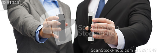 Image of businessman and businesswoman with smartphones