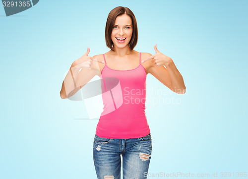 Image of woman in blank pink tank top pointing fingers