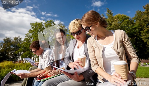 Image of group of happy students with notebooks and coffee