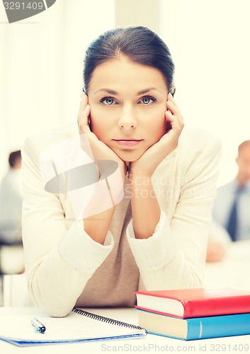 Image of stressed businesswoman in office