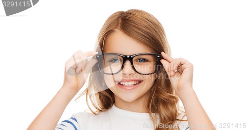 Image of smiling cute little girl with black eyeglasses