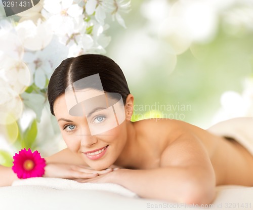 Image of happy beautiful woman lying in spa