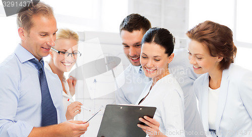 Image of business team discussing something in office