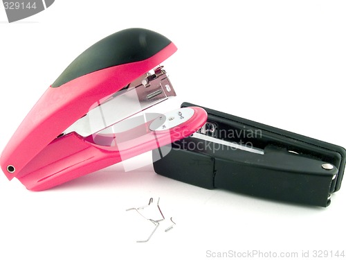 Image of Red and black staplers on a white background. isolated