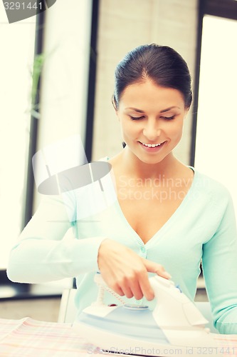 Image of lovely housewife with iron