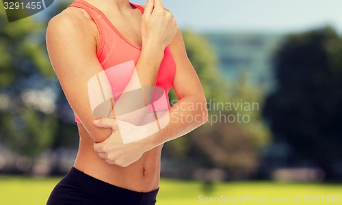 Image of sporty woman with pain in elbow