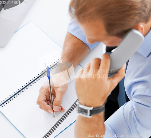 Image of handsome businessman talking on the phone