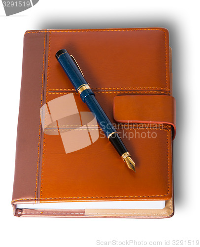 Image of Fountain pen on top of the closed notebook