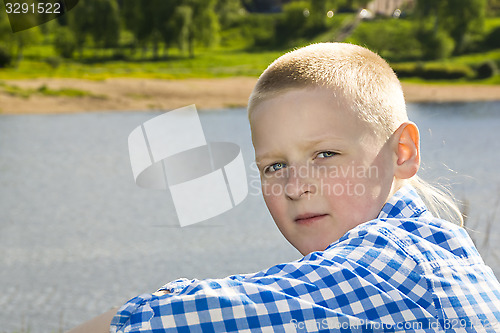 Image of Portrait of boy on summer river background