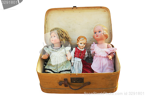 Image of three vintage doll in an old suitcase