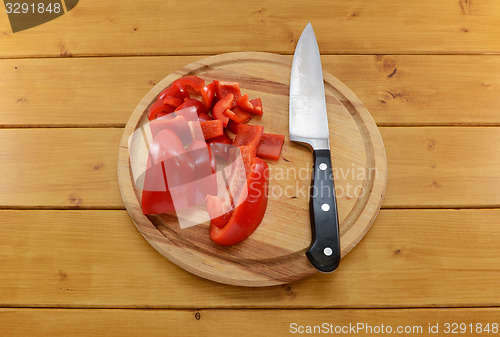 Image of Red pepper sliced with knife on a chopping board