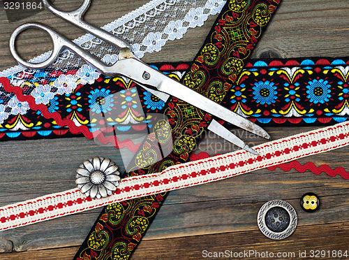 Image of vintage scissors, antique ribbons and classic buttons