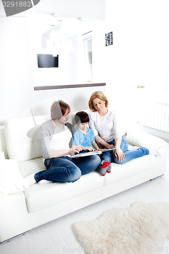 Image of Portrait of friendly family reading book