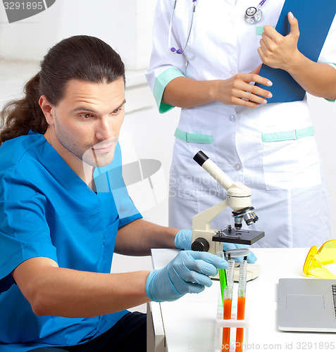 Image of researcher takes test tube in a laboratory