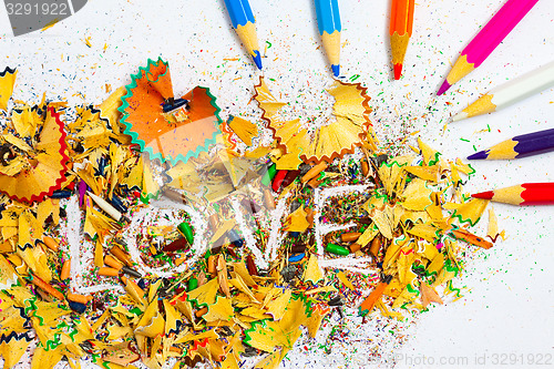 Image of The word LOVE on the background pencil shavings