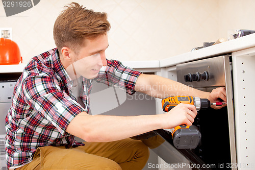 Image of worker installs a electric cooker