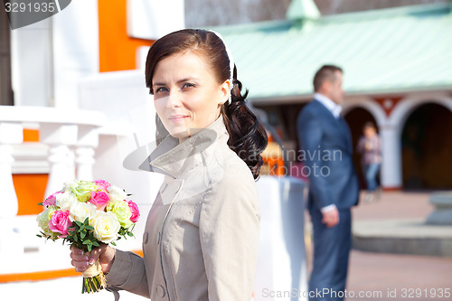 Image of beautiful young woman with a wedding bouquet