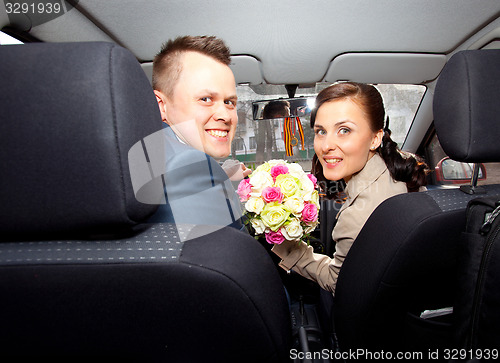 Image of bride and groom in a car